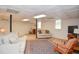 Open finished basement with wood flooring, a decorative ceiling, and a cozy seating area at 4366 Cedar Wood Sw Dr, Lilburn, GA 30047