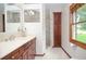 Bathroom featuring a stylish vanity, custom cabinets and a glass enclosed shower at 4366 Cedar Wood Sw Dr, Lilburn, GA 30047