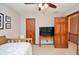 Bedroom featuring a TV, neutral walls and trim and wood doors at 4366 Cedar Wood Sw Dr, Lilburn, GA 30047