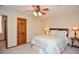 Comfortable bedroom with neutral walls, carpet and furnishings, as well as a ceiling fan at 4366 Cedar Wood Sw Dr, Lilburn, GA 30047