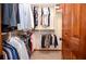 Walk-in closet featuring well-organized hanging rods and shelving for optimal storage solutions at 4366 Cedar Wood Sw Dr, Lilburn, GA 30047