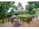 Outdoor deck with a barbecue grill, table with umbrella, and lush green yard in a peaceful setting at 4366 Cedar Wood Sw Dr, Lilburn, GA 30047