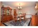 Formal dining room featuring classic furniture, a decorative chandelier, and a stylish area rug at 4366 Cedar Wood Sw Dr, Lilburn, GA 30047