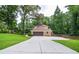 Long driveway leading to a two-car garage and a well-maintained yard at 4366 Cedar Wood Sw Dr, Lilburn, GA 30047
