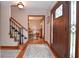Welcoming foyer with hardwood floors, a staircase, and an elegant entryway with a decorated front door at 4366 Cedar Wood Sw Dr, Lilburn, GA 30047