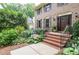 Elegant home entry with brick steps, wrought iron railings, and lush floral landscaping at 4366 Cedar Wood Sw Dr, Lilburn, GA 30047