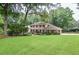 Beautiful two-story brick home with a well-manicured lawn, lush landscaping, and an attached garage at 4366 Cedar Wood Sw Dr, Lilburn, GA 30047