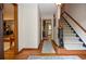 Inviting foyer featuring hardwood floors, a staircase, and views into adjoining rooms at 4366 Cedar Wood Sw Dr, Lilburn, GA 30047