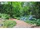Picturesque garden path lined with vibrant hydrangeas and lush greenery, creating a serene and inviting space at 4366 Cedar Wood Sw Dr, Lilburn, GA 30047