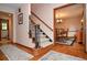 Hallway with hardwood floors, stairs, and an open dining room with a chandelier at 4366 Cedar Wood Sw Dr, Lilburn, GA 30047