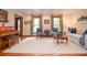 Bright living room with comfortable seating, large windows, and a decorative piano at 4366 Cedar Wood Sw Dr, Lilburn, GA 30047