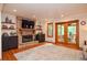 Cozy living room with a stone fireplace and access to a screened-in porch at 4366 Cedar Wood Sw Dr, Lilburn, GA 30047