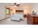 Bright main bedroom featuring a ceiling fan, dark wood furniture, and natural light at 4366 Cedar Wood Sw Dr, Lilburn, GA 30047