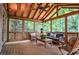 Relaxing sunroom features wood paneled ceiling and comfortable seating, perfect for enjoying the surrounding lush greenery at 4366 Cedar Wood Sw Dr, Lilburn, GA 30047