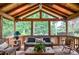Bright sunroom with wood-paneled ceiling, comfortable seating, and tranquil views of the surrounding greenery at 4366 Cedar Wood Sw Dr, Lilburn, GA 30047