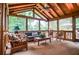 Inviting sunroom with wood paneled ceiling and beams, perfect for relaxing and enjoying nature views at 4366 Cedar Wood Sw Dr, Lilburn, GA 30047