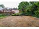 Spacious backyard with gravel, landscaping, and a view of the deck, offering ample outdoor space at 456 Harmony Grove Rd, Lilburn, GA 30047