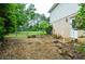 Backyard area near the house with chain-link fencing and lush landscaping at 456 Harmony Grove Rd, Lilburn, GA 30047