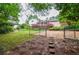 Expansive backyard featuring a wooden deck, lush greenery, and a gated area for added security at 456 Harmony Grove Rd, Lilburn, GA 30047