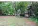 Backyard with a shed and a wooded area behind the house at 456 Harmony Grove Rd, Lilburn, GA 30047