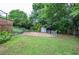 Grassy backyard and a fenced area behind the house at 456 Harmony Grove Rd, Lilburn, GA 30047