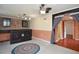 Basement bar with brick accents, adjacent room with red flooring, and doorway at 456 Harmony Grove Rd, Lilburn, GA 30047