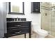 Bathroom with a black vanity, toilet, and glass shower at 456 Harmony Grove Rd, Lilburn, GA 30047