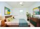 Bright bedroom with modern decor, a bed, and a ceiling fan at 456 Harmony Grove Rd, Lilburn, GA 30047