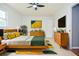 Modern bedroom with a bed, dresser, and a ceiling fan at 456 Harmony Grove Rd, Lilburn, GA 30047