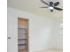 Bedroom closet with white walls, ceiling fan and carpet at 456 Harmony Grove Rd, Lilburn, GA 30047