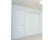 Bright bedroom featuring a ceiling fan, closet and white doors at 456 Harmony Grove Rd, Lilburn, GA 30047