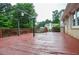 Spacious deck with a red stain and a black pergola, offering a great space for relaxing outdoors at 456 Harmony Grove Rd, Lilburn, GA 30047