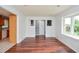 Dining room with hardwood floors, large windows, and an adjacent kitchen area at 456 Harmony Grove Rd, Lilburn, GA 30047