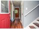 Entryway featuring hardwood floors, stairs, and a glimpse of the kitchen at 456 Harmony Grove Rd, Lilburn, GA 30047