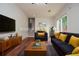 Staged living room featuring a blue sofa, rug, and stairs at 456 Harmony Grove Rd, Lilburn, GA 30047