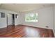 Spacious living room with hardwood floors, a large window, and a view of the entryway at 456 Harmony Grove Rd, Lilburn, GA 30047