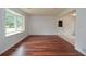 Bright living room with large windows, hardwood floors, and neutral walls at 456 Harmony Grove Rd, Lilburn, GA 30047