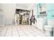 Tiled utility room with a water heater and other utility equipment, plus sink and toilet at 456 Harmony Grove Rd, Lilburn, GA 30047