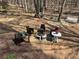 Outdoor fire pit and seating area amid mature trees create a relaxing and inviting gathering spot at 465 Woodbrook Ways, Lawrenceville, GA 30043