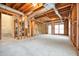 Unfinished basement featuring exposed ductwork, stairs, and natural light through a double window at 465 Woodbrook Ways, Lawrenceville, GA 30043