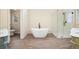 Bright bathroom featuring soaking tub, glass shower, and double sink vanity at 465 Woodbrook Ways, Lawrenceville, GA 30043