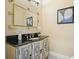 Charming bathroom featuring a vanity with marble countertop, decorative mirror and neutral paint at 465 Woodbrook Ways, Lawrenceville, GA 30043