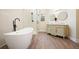 Bathroom featuring soaking tub, glass shower, and double sink vanity at 465 Woodbrook Ways, Lawrenceville, GA 30043