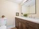 Bathroom featuring a dark wood double vanity with a double sink and stylish fixtures at 465 Woodbrook Ways, Lawrenceville, GA 30043