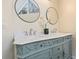 Close-up of ornate bathroom vanity with marble countertop and dual sinks at 465 Woodbrook Ways, Lawrenceville, GA 30043