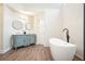 Elegant bathroom featuring soaking tub, glass shower, and vintage-inspired double sink vanity at 465 Woodbrook Ways, Lawrenceville, GA 30043