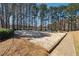 Community beach volleyball court with soft sand, surrounded by mature trees and foliage at 465 Woodbrook Ways, Lawrenceville, GA 30043