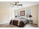 Cozy bedroom with hardwood floors, a ceiling fan, and windows providing natural light at 465 Woodbrook Ways, Lawrenceville, GA 30043