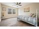 Bright bedroom featuring hardwood floors, a ceiling fan, and a window that provides ample natural light at 465 Woodbrook Ways, Lawrenceville, GA 30043
