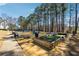 Community bocce ball court with seating, surrounded by trees, grass and blue sky at 465 Woodbrook Ways, Lawrenceville, GA 30043